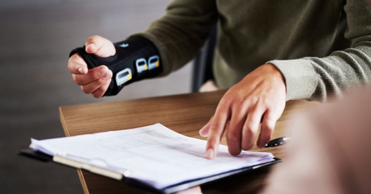 Injured Texas woman signing paperwork to file a case with the Law Offices of Vic Feazell